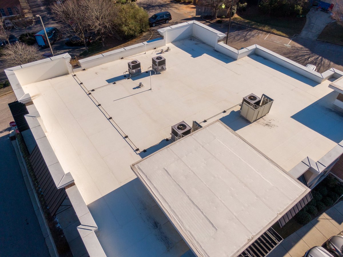 Commercial and industrial buildings with white TPO flat roofing systems